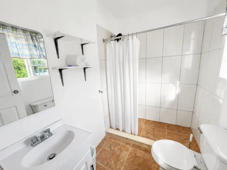 Clean bathroom and shower in Coastal Vista Room 2 at Da Villa Juanita