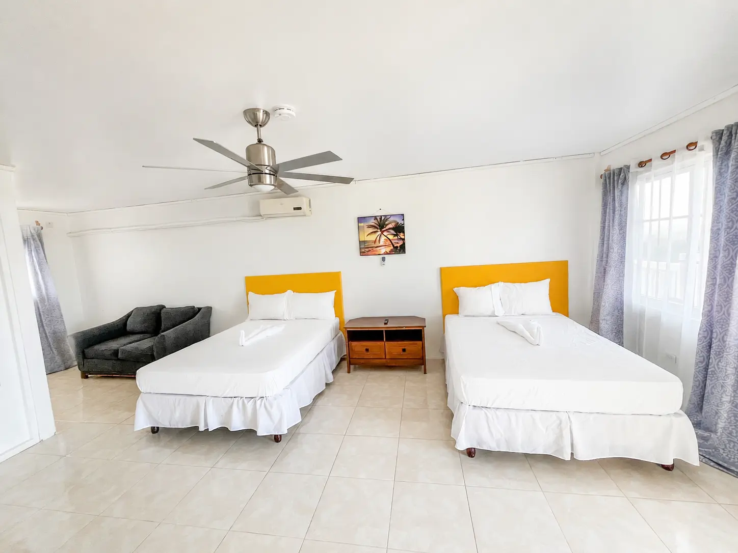 Front view of two double beds in Coastal Vista Room 2 at Da Villa Juanita