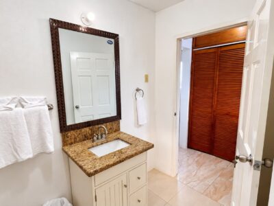 Grand Pavilion ensuite bathroom vanity with towels and closet area at Da Villa Juanita